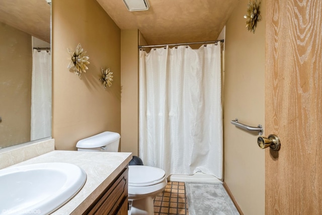 bathroom featuring vanity, curtained shower, tile patterned floors, and toilet