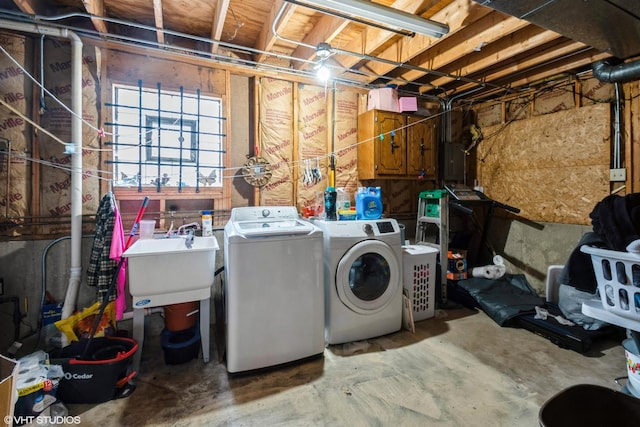 clothes washing area with washer and dryer and sink