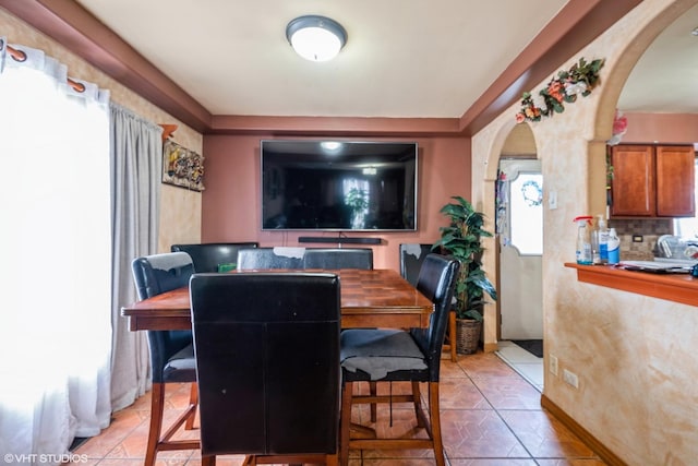 tiled dining room with plenty of natural light