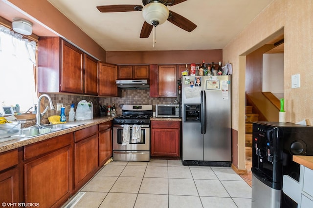 kitchen with sink, ceiling fan, stainless steel appliances, tasteful backsplash, and light tile patterned flooring