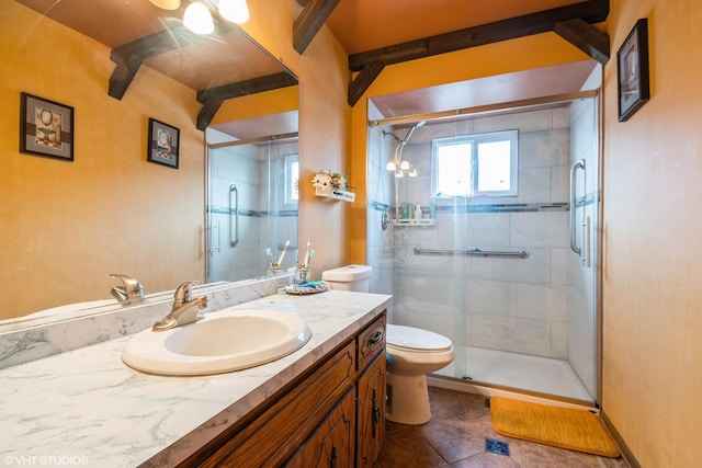 bathroom with a shower with door, vanity, tile patterned flooring, and toilet