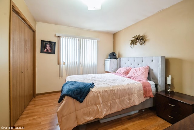 bedroom featuring a closet and light wood-type flooring