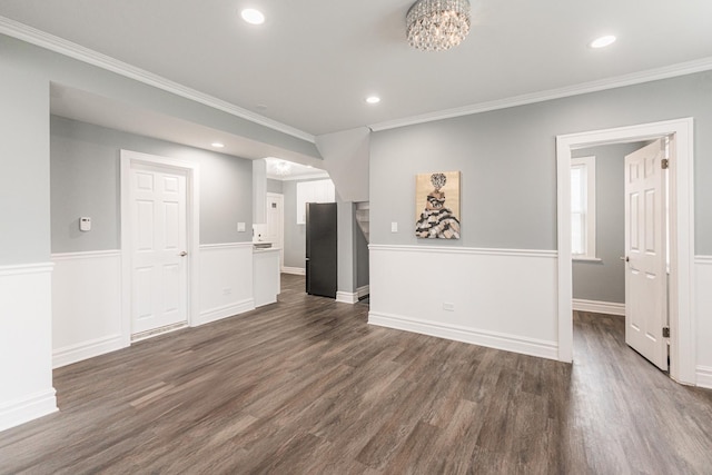 unfurnished living room with crown molding and dark wood-type flooring