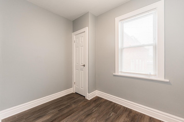 unfurnished room featuring dark wood-type flooring