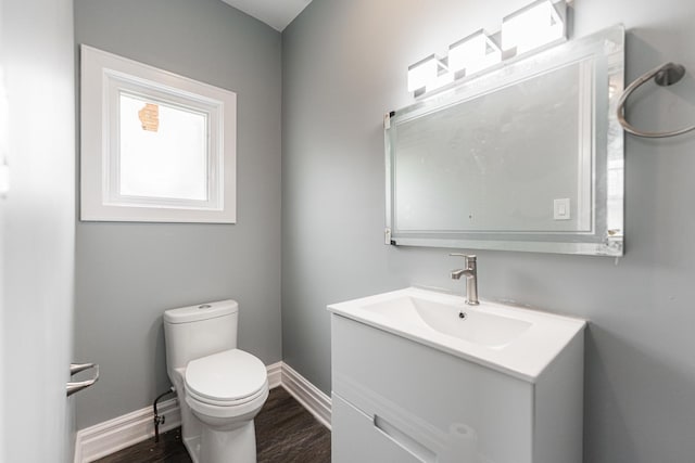 bathroom featuring vanity, wood-type flooring, and toilet