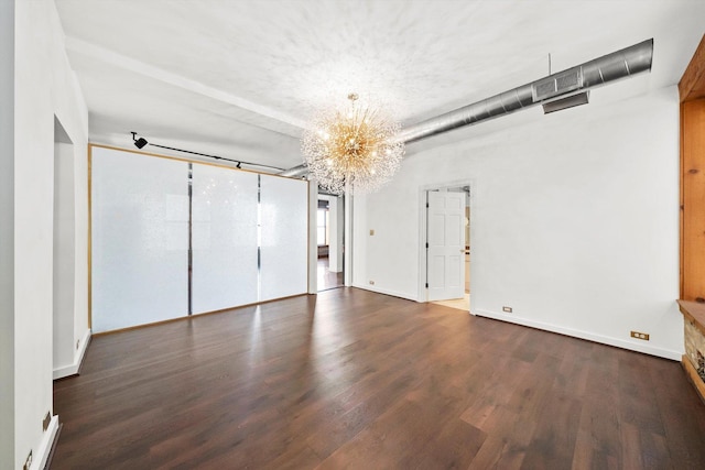 unfurnished bedroom featuring dark hardwood / wood-style flooring and a notable chandelier