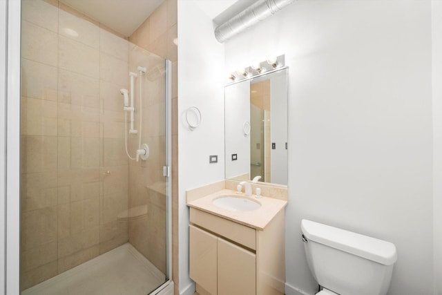 bathroom featuring walk in shower, vanity, and toilet