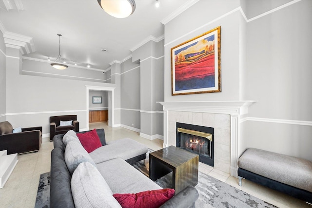 living room with a tile fireplace and ornamental molding