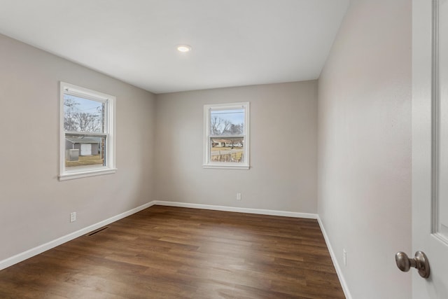 spare room with dark hardwood / wood-style floors