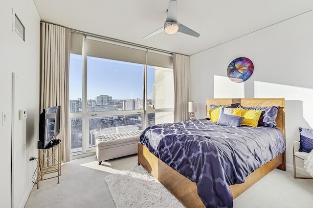 bedroom featuring ceiling fan and light carpet