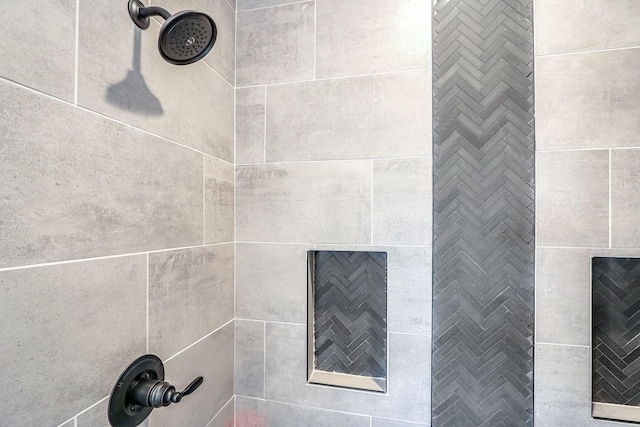 details featuring a tile fireplace and a tile shower