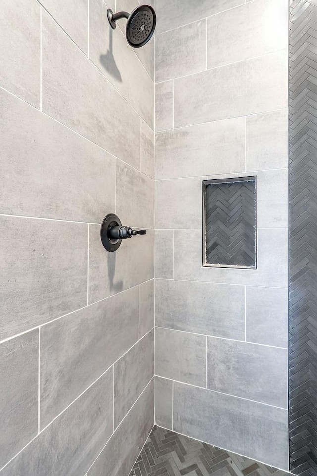 bathroom with tiled shower