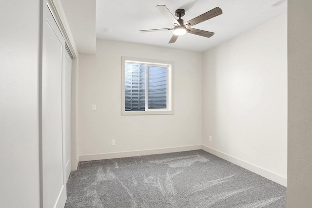 unfurnished bedroom with ceiling fan and carpet