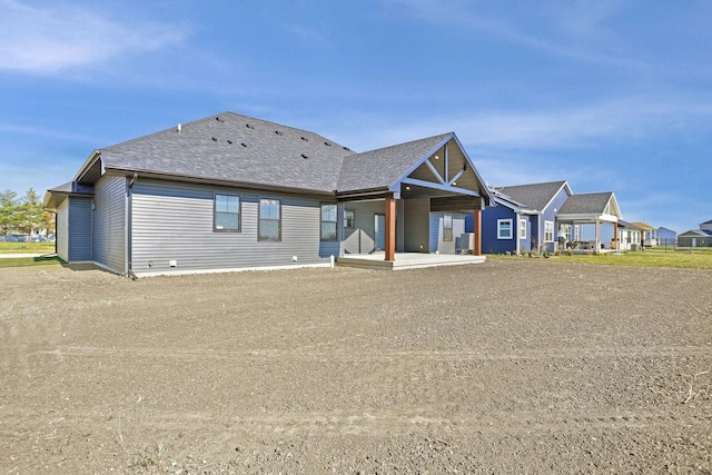 back of property with a patio and central AC