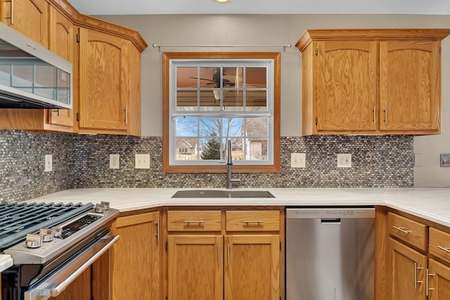 kitchen with sink, decorative backsplash, and stainless steel appliances