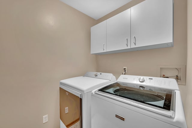 laundry area with cabinets and separate washer and dryer