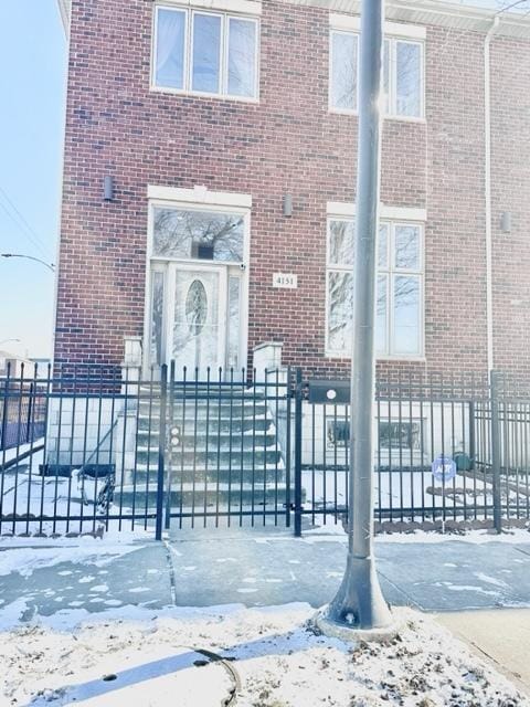 view of snow covered property entrance