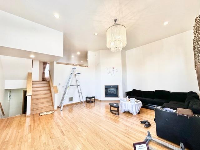 living room with wood-type flooring and a chandelier