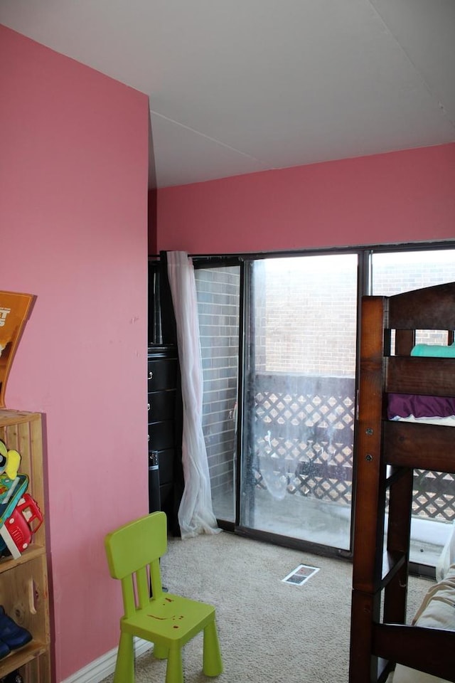 bedroom featuring multiple windows and carpet