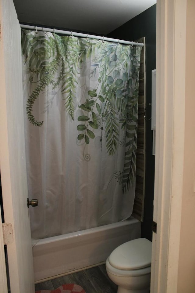 bathroom with shower / bathtub combination with curtain, wood-type flooring, and toilet