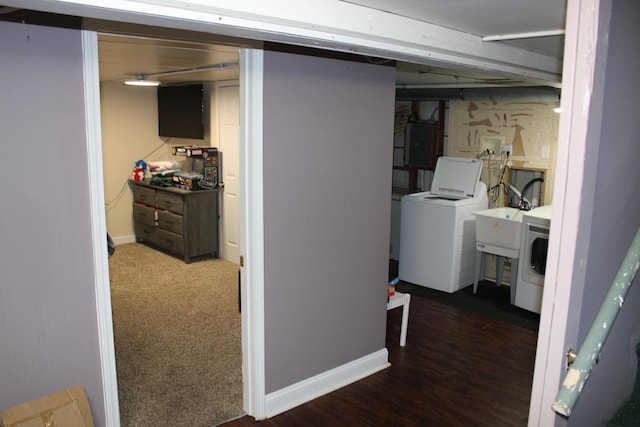 laundry room featuring sink, dark hardwood / wood-style floors, electric panel, and washing machine and dryer