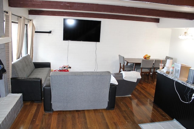 living room with brick wall, dark hardwood / wood-style floors, and beam ceiling