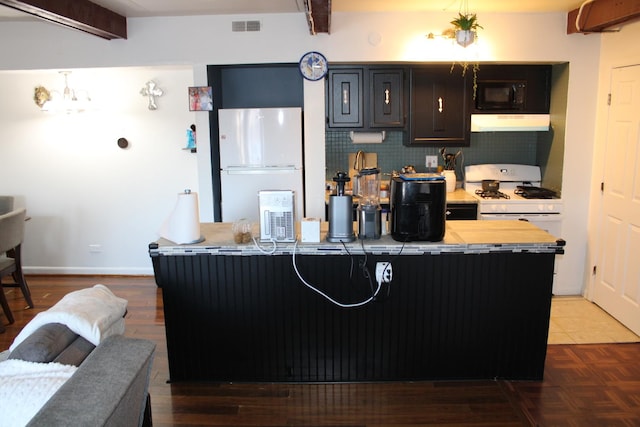 kitchen with a kitchen bar, white appliances, and decorative backsplash