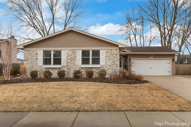 ranch-style home featuring a garage and a front lawn