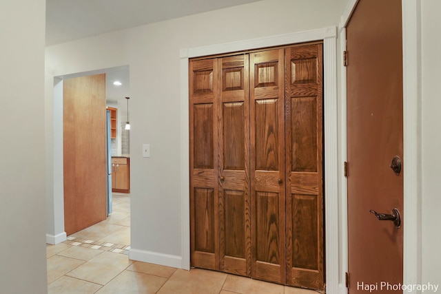 hall with light tile patterned floors