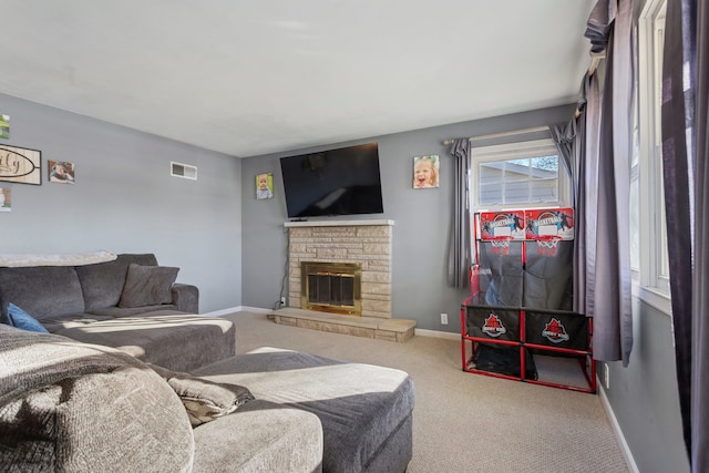 carpeted living room with a fireplace