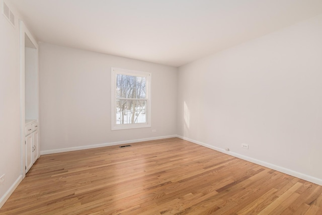 spare room with light hardwood / wood-style floors