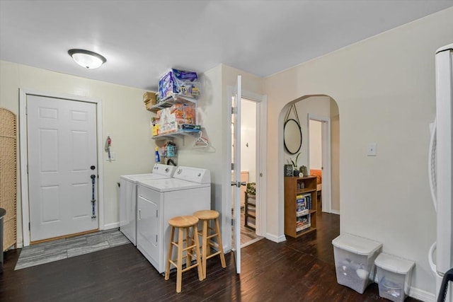 laundry area with independent washer and dryer and dark hardwood / wood-style floors