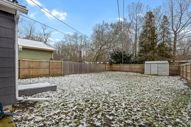 snowy yard featuring a shed