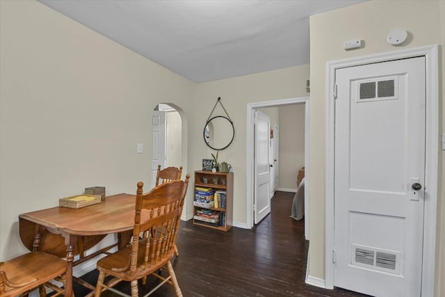 dining space featuring dark hardwood / wood-style floors