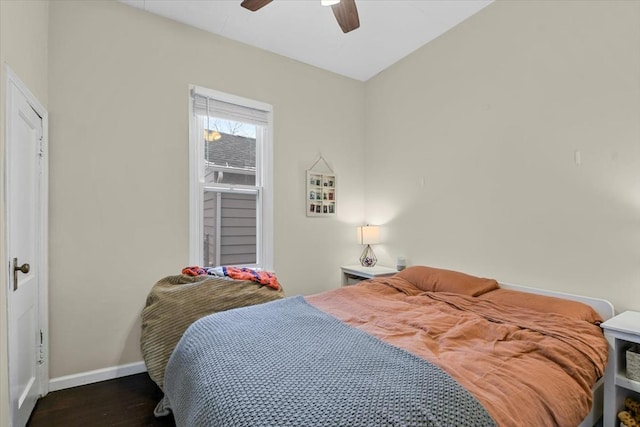 bedroom with dark hardwood / wood-style floors and ceiling fan