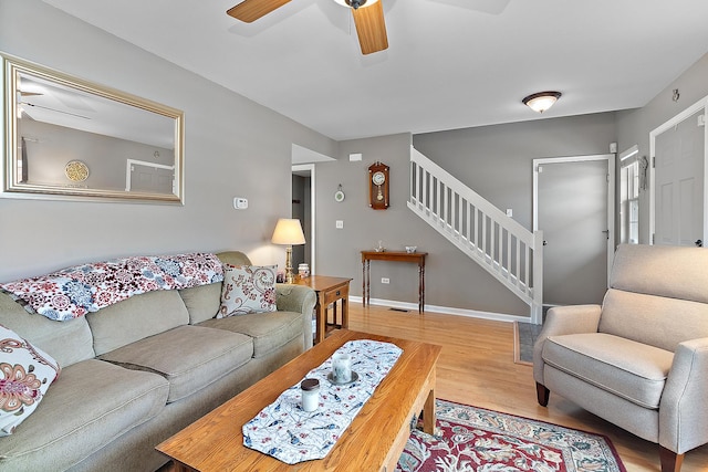 living room featuring hardwood / wood-style flooring and ceiling fan