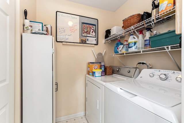 clothes washing area with washing machine and dryer