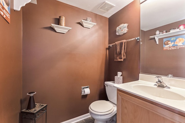 bathroom featuring vanity and toilet