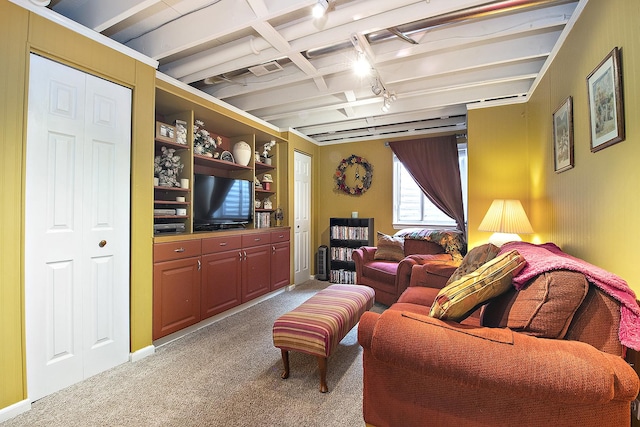 carpeted living room with built in shelves and beamed ceiling