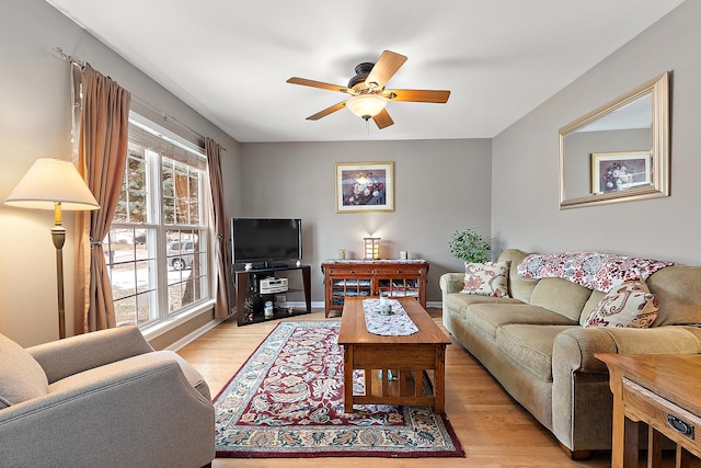 living room with ceiling fan and light hardwood / wood-style floors