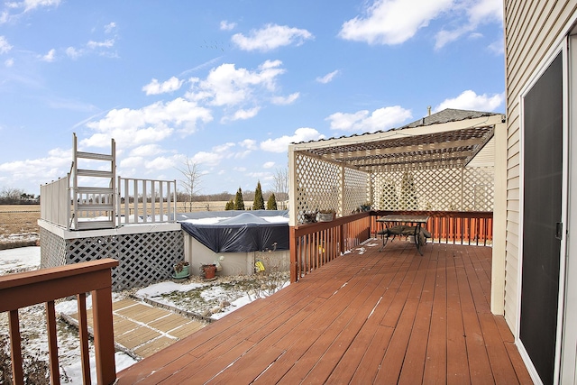 snow covered deck featuring a pergola and a covered pool