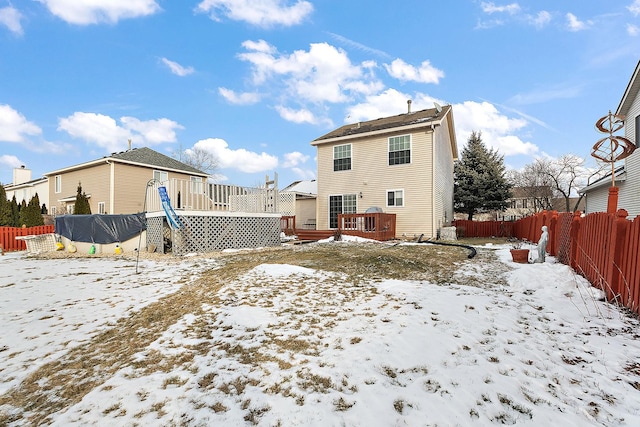 snow covered property with a deck