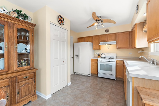 kitchen featuring ceiling fan, white appliances, and sink