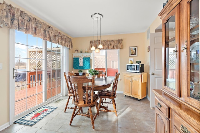 dining space featuring light tile patterned floors