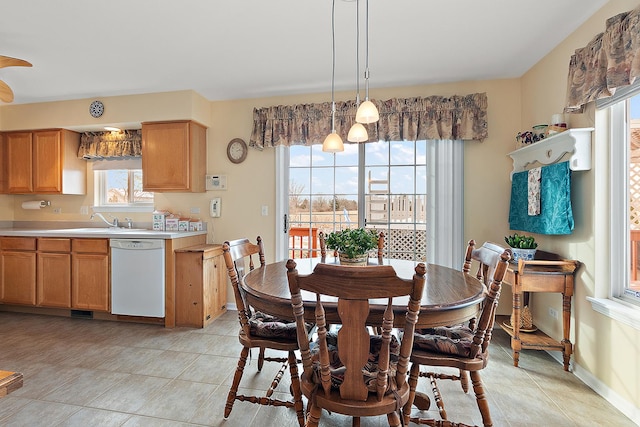 dining room featuring light tile patterned floors, sink, and a wealth of natural light