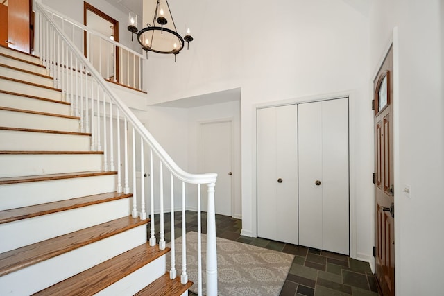 foyer featuring a notable chandelier and a high ceiling