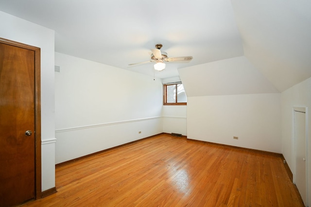 additional living space with ceiling fan, lofted ceiling, and light hardwood / wood-style flooring