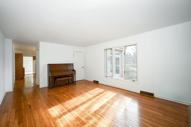 unfurnished living room with wood-type flooring