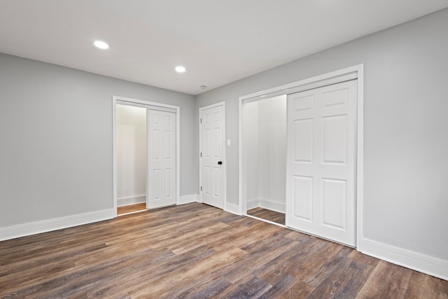 unfurnished bedroom with dark wood-type flooring