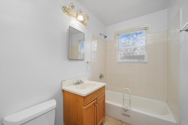 full bathroom with tile patterned flooring, vanity, tiled shower / bath combo, and toilet